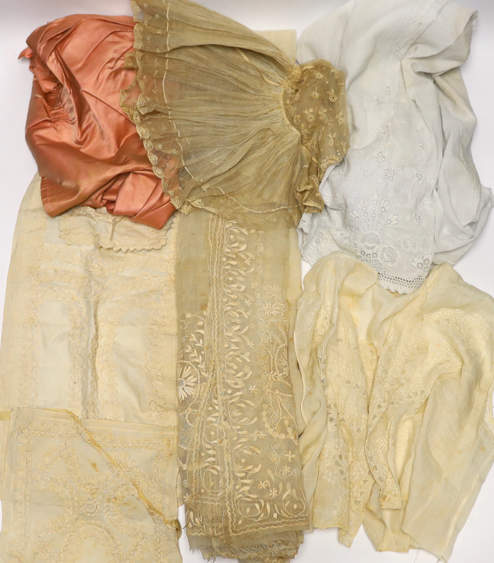 An 18th century Dresden worked apron, a white worked fine lawn stole, two panels of linen ribbon work, a ladies lace bonnet a similar pink satin bonnet a white worked blouse (partially made) and panel to a christening go